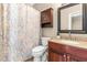 Half bathroom with modern fixtures, granite countertop, and paisley shower curtain at 8600 Clivedon Dr, Raleigh, NC 27615
