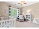 Charming Bedroom with a crib, glider, and whimsical dinosaur decor at 8600 Clivedon Dr, Raleigh, NC 27615