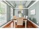 Elegant dining room featuring stylish lighting fixture, tray ceiling, and neutral color palette at 8600 Clivedon Dr, Raleigh, NC 27615
