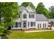 Charming two-story home with a well-maintained lawn and surrounded by lush greenery at 8600 Clivedon Dr, Raleigh, NC 27615