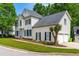 Traditional two-story house with a two-car garage and well-kept landscaping in a suburban setting at 8600 Clivedon Dr, Raleigh, NC 27615