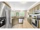 Well-equipped kitchen featuring stainless steel appliances and granite countertops, adjacent to a cozy dining area at 8600 Clivedon Dr, Raleigh, NC 27615