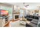 Welcoming living room features fireplace, wood floors and easy access to the kitchen at 8600 Clivedon Dr, Raleigh, NC 27615
