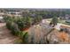 This aerial shot showcases a property's setting amongst mature trees and its location near a quiet road at 900 Roxboro Road, Oxford, NC 27565