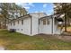 The back of a white house with white trim and a small awning at 900 Roxboro Road, Oxford, NC 27565