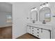 Bathroom featuring a double vanity with shaker cabinets and modern mirrors at 900 Roxboro Road, Oxford, NC 27565