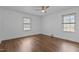 Bright bedroom with hardwood floors, two windows and a ceiling fan at 900 Roxboro Road, Oxford, NC 27565
