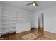 Bedroom with hardwood floors, built-in shelving and a ceiling fan at 900 Roxboro Road, Oxford, NC 27565