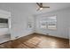 Bedroom featuring hardwood floors, two windows, a ceiling fan and an open door at 900 Roxboro Road, Oxford, NC 27565