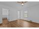 Bright bedroom featuring wood-look floors, ceiling fan, and walk-in closet access at 900 Roxboro Road, Oxford, NC 27565