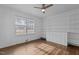 Bedroom featuring hardwood floors, built-in shelving, a window, and ceiling fan at 900 Roxboro Road, Oxford, NC 27565