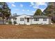 Charming single-story home featuring a white brick exterior and a well-maintained lawn at 900 Roxboro Road, Oxford, NC 27565