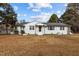 Charming single-story home featuring a white brick exterior and a well-maintained lawn at 900 Roxboro Road, Oxford, NC 27565