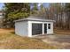 Exterior view of a detached one car garage showing gray siding and a black garage door at 900 Roxboro Road, Oxford, NC 27565