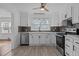 Bright kitchen features white cabinets, stainless appliances, and stylish backsplash at 900 Roxboro Road, Oxford, NC 27565