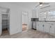 Kitchen featuring white cabinets, stainless steel dishwasher, and wood flooring at 900 Roxboro Road, Oxford, NC 27565