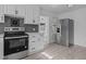 Modern kitchen featuring stainless steel appliances, subway tile backsplash, and bright lighting at 900 Roxboro Road, Oxford, NC 27565