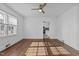 Sun-filled living area with hardwood floors, a ceiling fan, and access to the adjacent kitchen at 900 Roxboro Road, Oxford, NC 27565