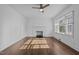 Bright living room featuring hardwood floors, a cozy fireplace, and large windows allowing ample natural light at 900 Roxboro Road, Oxford, NC 27565