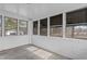 Inviting porch with tiled floor and multiple windows offers views of surrounding greenery at 900 Roxboro Road, Oxford, NC 27565