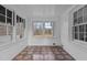 Bright, airy porch with tiled floors and multiple windows framing scenic outdoor views at 900 Roxboro Road, Oxford, NC 27565