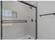 Modern bathroom shower featuring glass door and gray tile at 900 Roxboro Road, Oxford, NC 27565