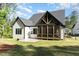 Backyard view shows a well-maintained lawn, wooden fence, and cozy screened-in porch at 904 Harrison Ridge Rd, Wake Forest, NC 27587
