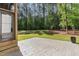 Backyard patio looks out over a large lawn with mature trees and landscaping at 904 Harrison Ridge Rd, Wake Forest, NC 27587