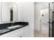 Modern bathroom featuring a vanity with black countertop and an arch mirror at 904 Harrison Ridge Rd, Wake Forest, NC 27587