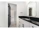 Modern bathroom featuring a vanity with black countertop and an arch mirror at 904 Harrison Ridge Rd, Wake Forest, NC 27587