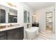 Modern bathroom featuring dual vanities, a standalone tub, and marble floors and countertops at 904 Harrison Ridge Rd, Wake Forest, NC 27587