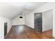 Bright bedroom boasts hardwood floors, a dormer window, and modern trim and door at 904 Harrison Ridge Rd, Wake Forest, NC 27587