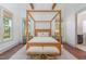 Bright primary bedroom featuring a four-poster bed, wood floors, and bright sunny windows at 904 Harrison Ridge Rd, Wake Forest, NC 27587