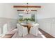 Elegant dining room with a round wooden table, white chairs, and a modern chandelier at 904 Harrison Ridge Rd, Wake Forest, NC 27587