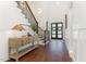 Welcoming foyer with hardwood floors, a staircase with wrought iron railings, and stylish console table at 904 Harrison Ridge Rd, Wake Forest, NC 27587