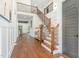 Bright and airy foyer with hardwood floors, a staircase with wrought iron railings, and elegant decor at 904 Harrison Ridge Rd, Wake Forest, NC 27587