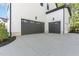 Attached two-car garage features a concrete driveway and neutral color palette at 904 Harrison Ridge Rd, Wake Forest, NC 27587