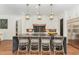 Well-designed kitchen island with pendant lighting and white cabinets and stainless appliances at 904 Harrison Ridge Rd, Wake Forest, NC 27587