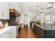 Well-equipped kitchen with marble countertops, stainless steel appliances, and stylish dark backsplash at 904 Harrison Ridge Rd, Wake Forest, NC 27587
