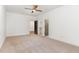 Spacious main bedroom with a ceiling fan, multiple doors and neutral carpet at 904 Harrison Ridge Rd, Wake Forest, NC 27587