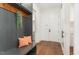 Inviting mudroom with bench, coat hooks, and hardwood floors at 904 Harrison Ridge Rd, Wake Forest, NC 27587