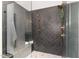 Modern shower featuring herringbone tile, glass enclosure, and elegant fixtures at 904 Harrison Ridge Rd, Wake Forest, NC 27587