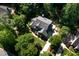 Aerial view of a beautiful home nestled among mature trees, showcasing its architectural details and private surroundings at 945 Jones Wynd, Wake Forest, NC 27587