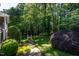 Lush backyard with stone pathway leading to a wooded area, enhancing the property's privacy and serene atmosphere at 945 Jones Wynd, Wake Forest, NC 27587