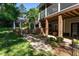 Landscaped backyard with a stone pathway, water feature, and brick-supported porch at 945 Jones Wynd, Wake Forest, NC 27587
