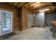 Unfinished basement with exposed ceiling, access to the outside, and concrete block walls at 945 Jones Wynd, Wake Forest, NC 27587