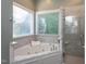Bathroom featuring tub, tiled shower and natural light at 945 Jones Wynd, Wake Forest, NC 27587