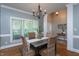 Dining room with decorative chandelier, trim and woodwork with a neutral color palette at 945 Jones Wynd, Wake Forest, NC 27587