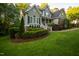 Charming two-story home with manicured lawn and lush landscaping at 945 Jones Wynd, Wake Forest, NC 27587