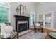 Living room with fireplace, hardwood floors, and natural light at 945 Jones Wynd, Wake Forest, NC 27587